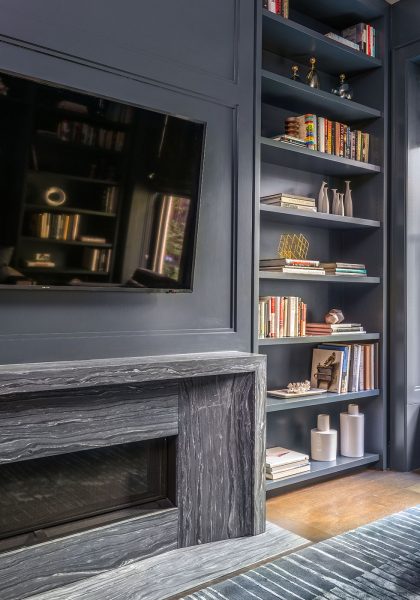 blue bookshelves, blue den, built in bookshelves around fireplace