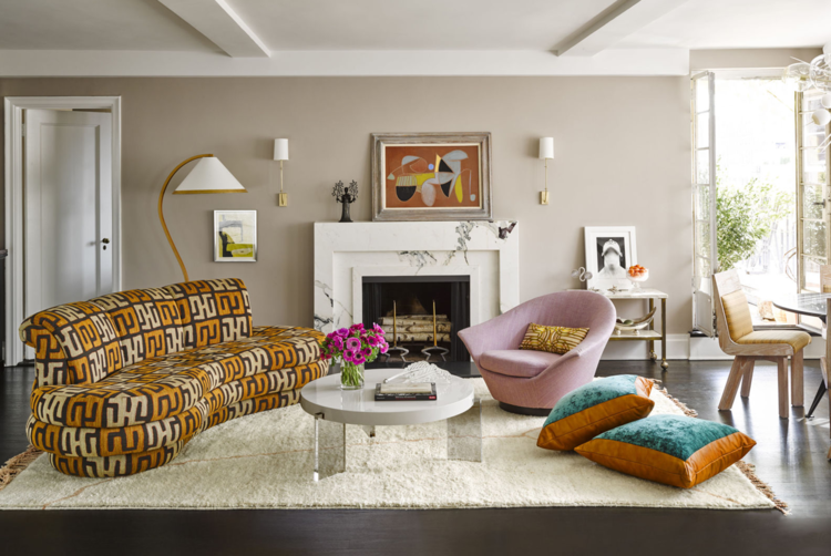 fabulous curved sofa in a leopard orange and white print with pink chair, marble coffee table, shag rug and turquoise pillows